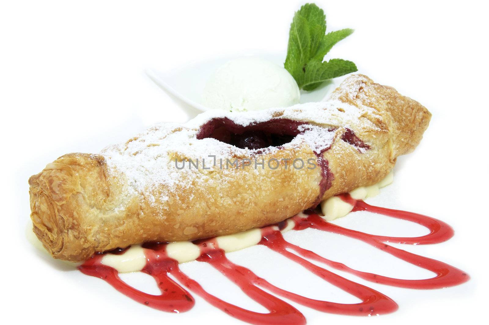 berry strudel on a white background decorated with mint