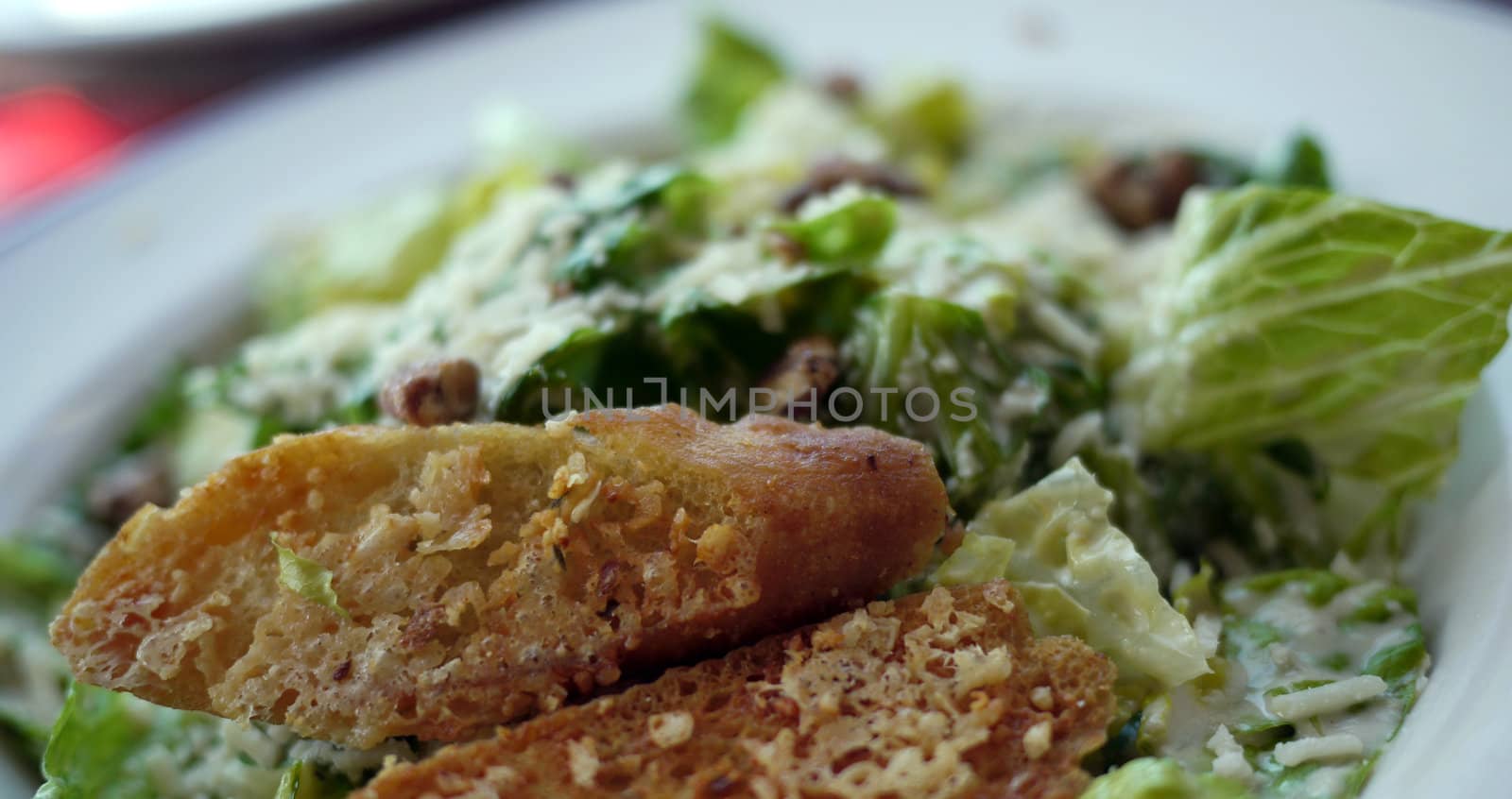 crouton on a ceasar salad by seattlephoto