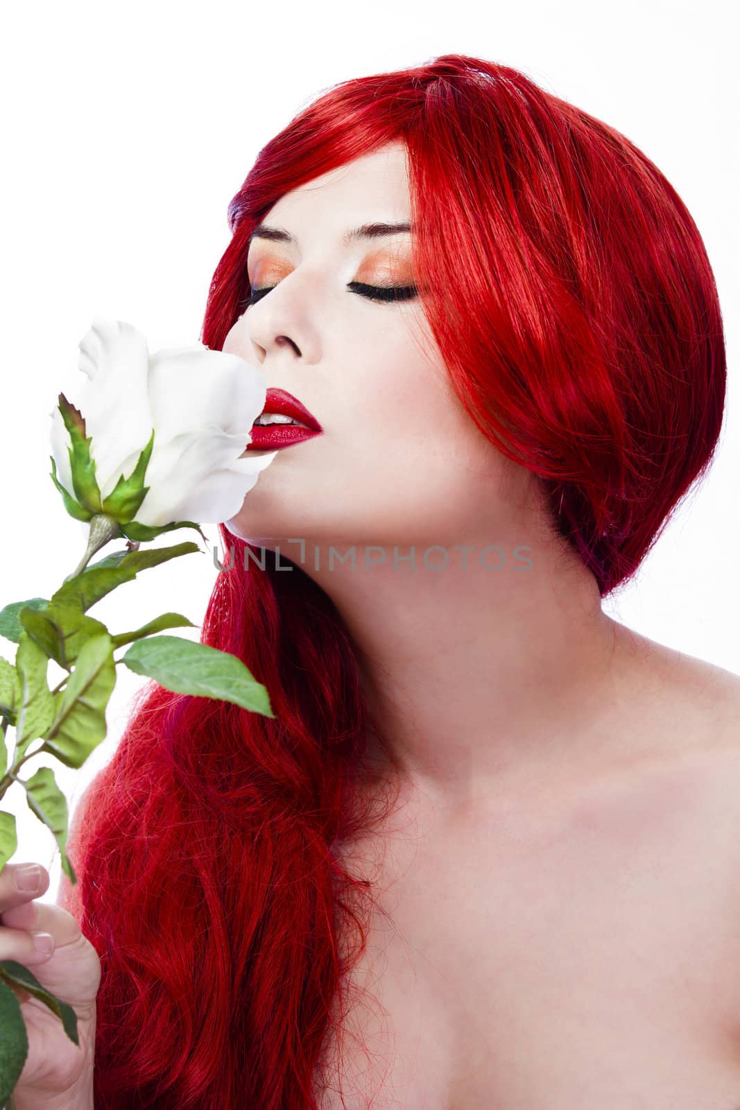 smelling a white rose, spring concept.Red Hair woman. Fashion Girl Portrait.