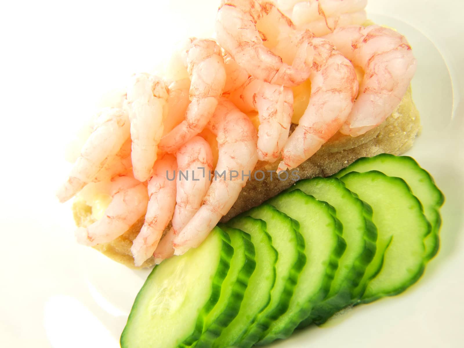 Shrimp sandwich with cucumber, isolated towards white
