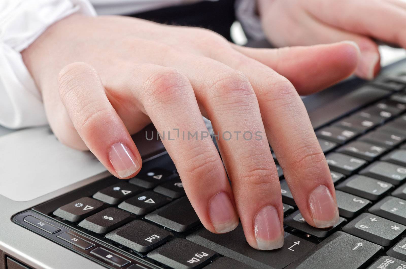woman hand over the laptop computer keyboard,horizontal shot