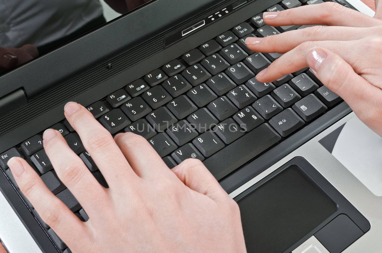 woman entering text on the laptop computer keyboard