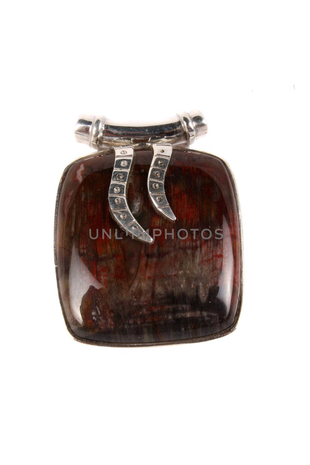 A Jasper pendant made of silver used as jewelery or alternate therapy method in crystal healing on astrology, isolated on white studio background.