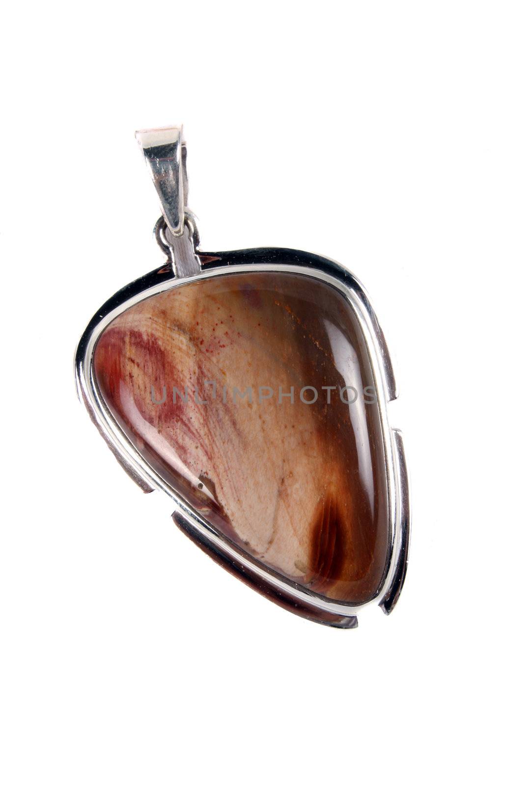 A Petriwood pendant made of silver used in alternative therapies like crystal healing and astrology, isolated on white studio background.