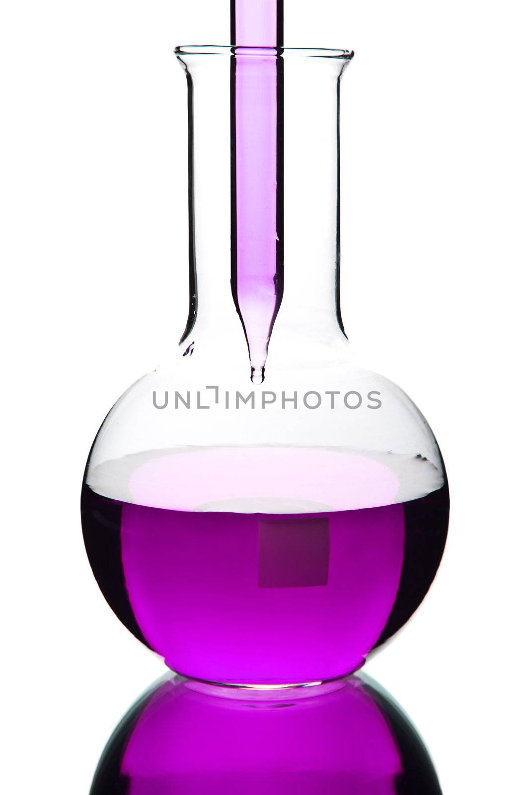 liquid dripping from pipette into flask isolated 