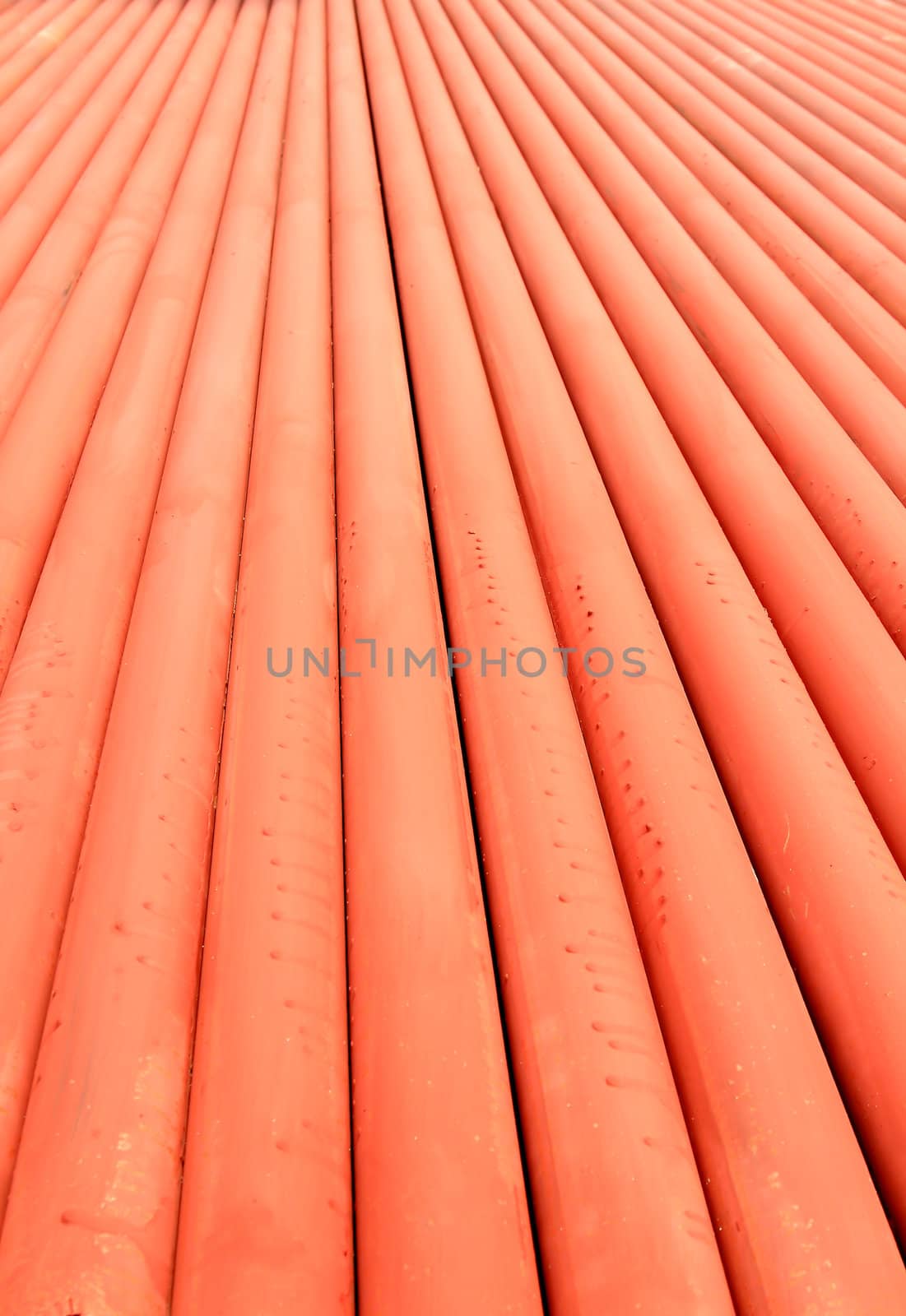 Stack of metallic pipes in a construction site  by rufous