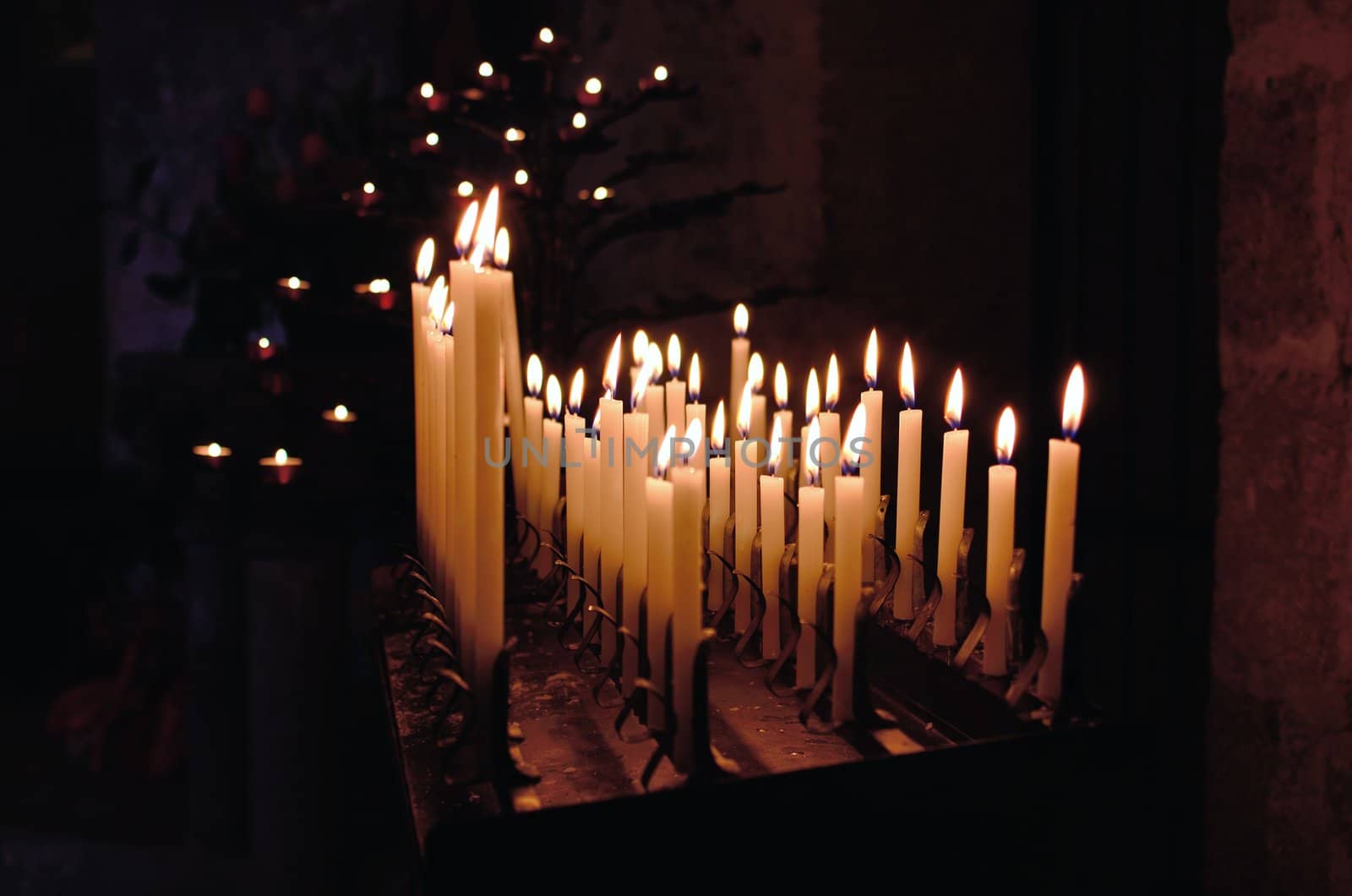 Some church candles against a dark background