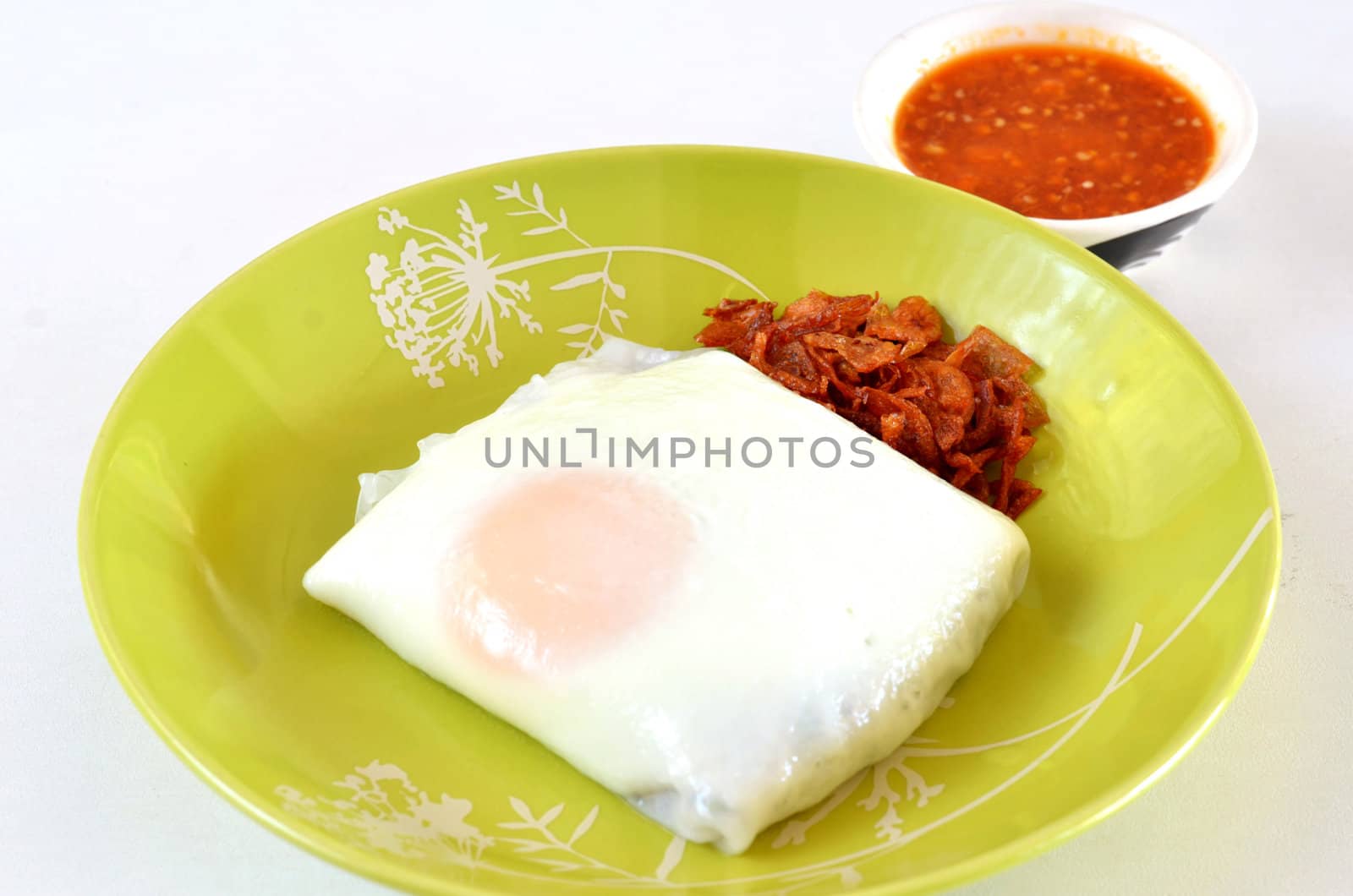 Vietnamese rice noodle rolls with a filling of pork sliced and  egg  ,  served with  fried onion , spicy sauce