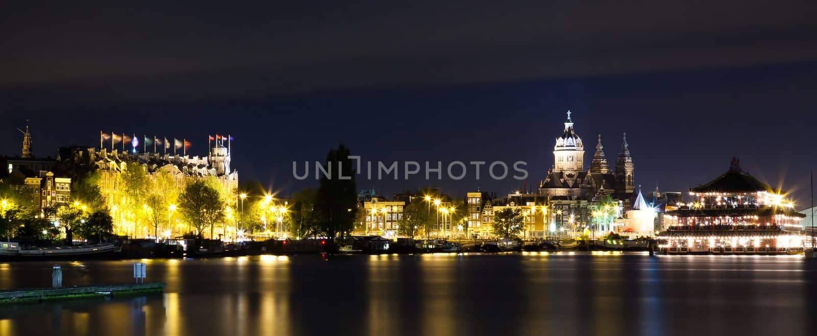 Amsterdam night panorama - view on Sea Palace, Church of St. Nicholas and Grand Hotel Amrath - long time exposure