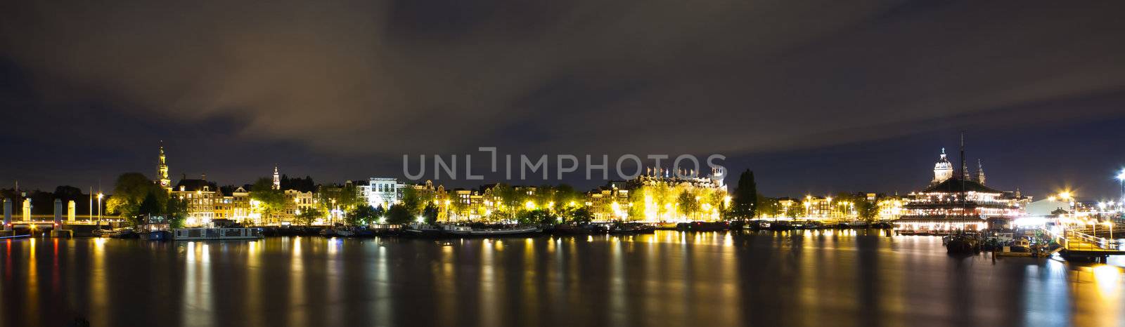 Amsterdam night panorama - view on Sea Palace, Church of St. Nicholas and Grand Hotel Amrath - long time exposure