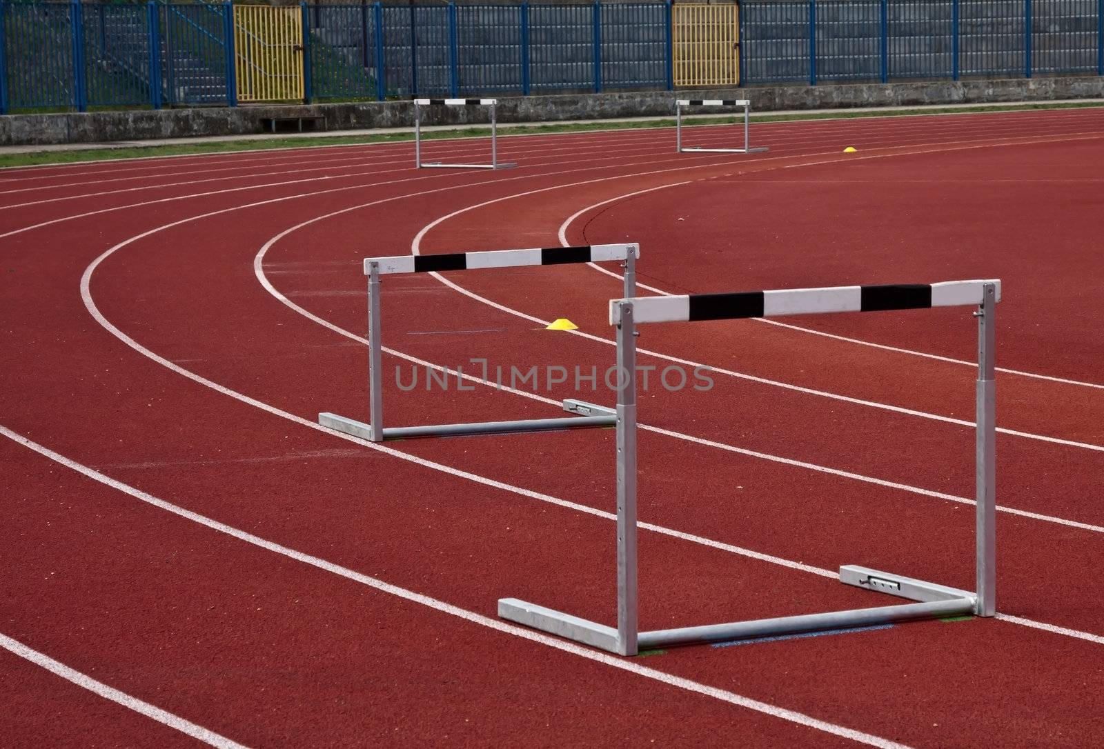 athletic stadium and some hurdles in athletic lines