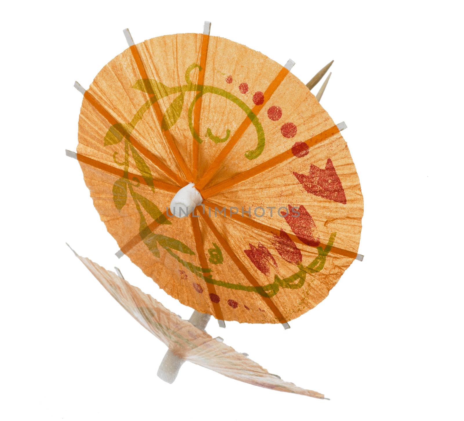 Orange cocktail umbrella on white