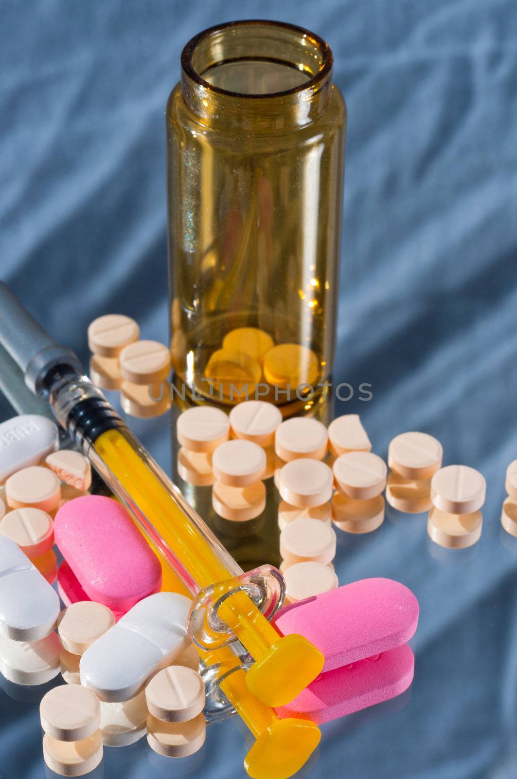Medicine bottle and syringe and pills and reflection