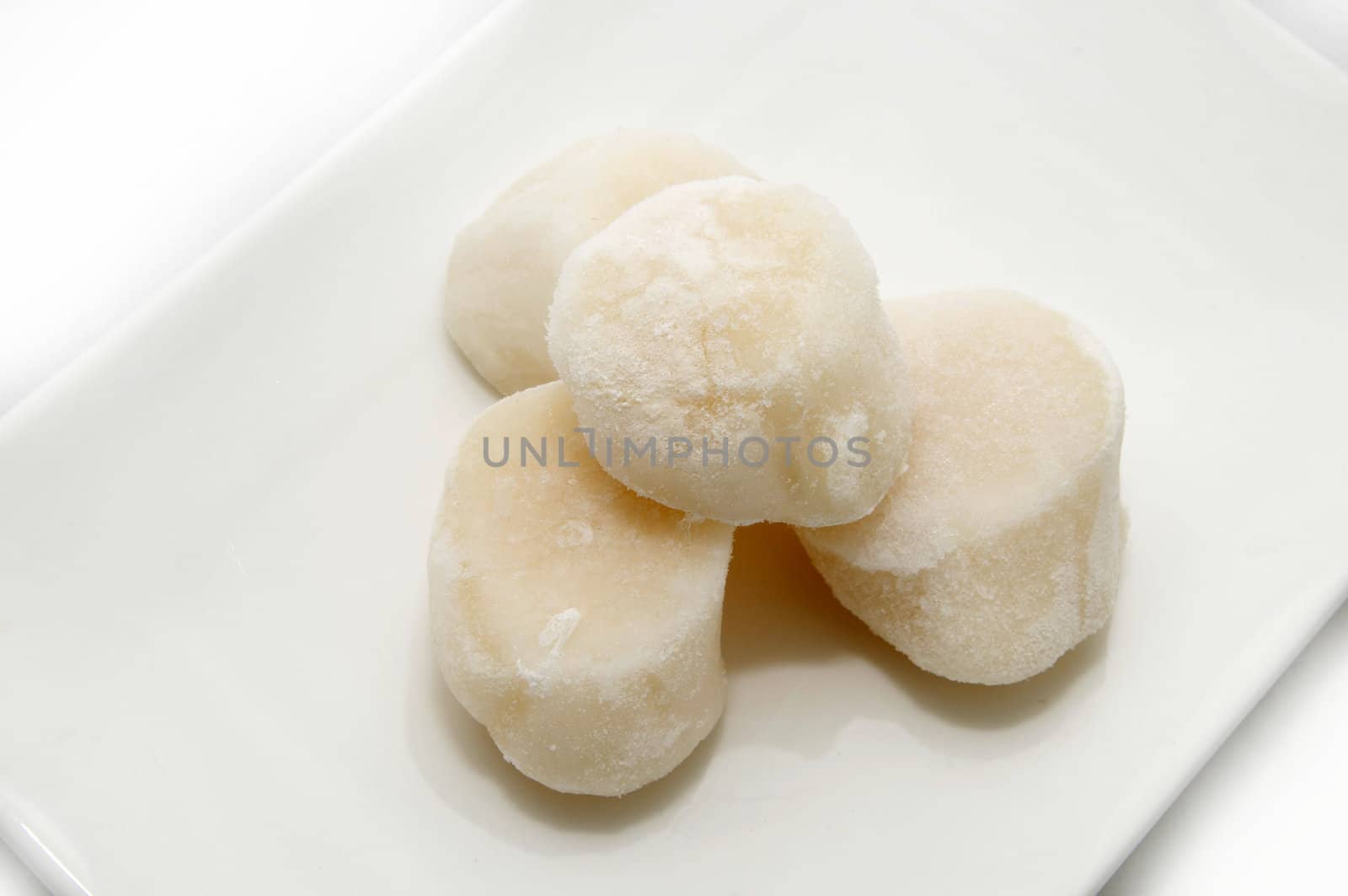 a plate of frozen scallops on a white background