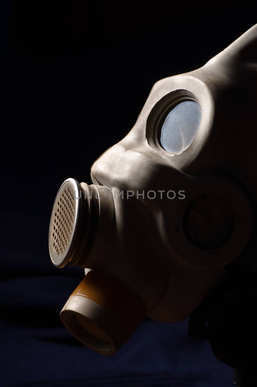 Closeup of a gasmask with blue dark background