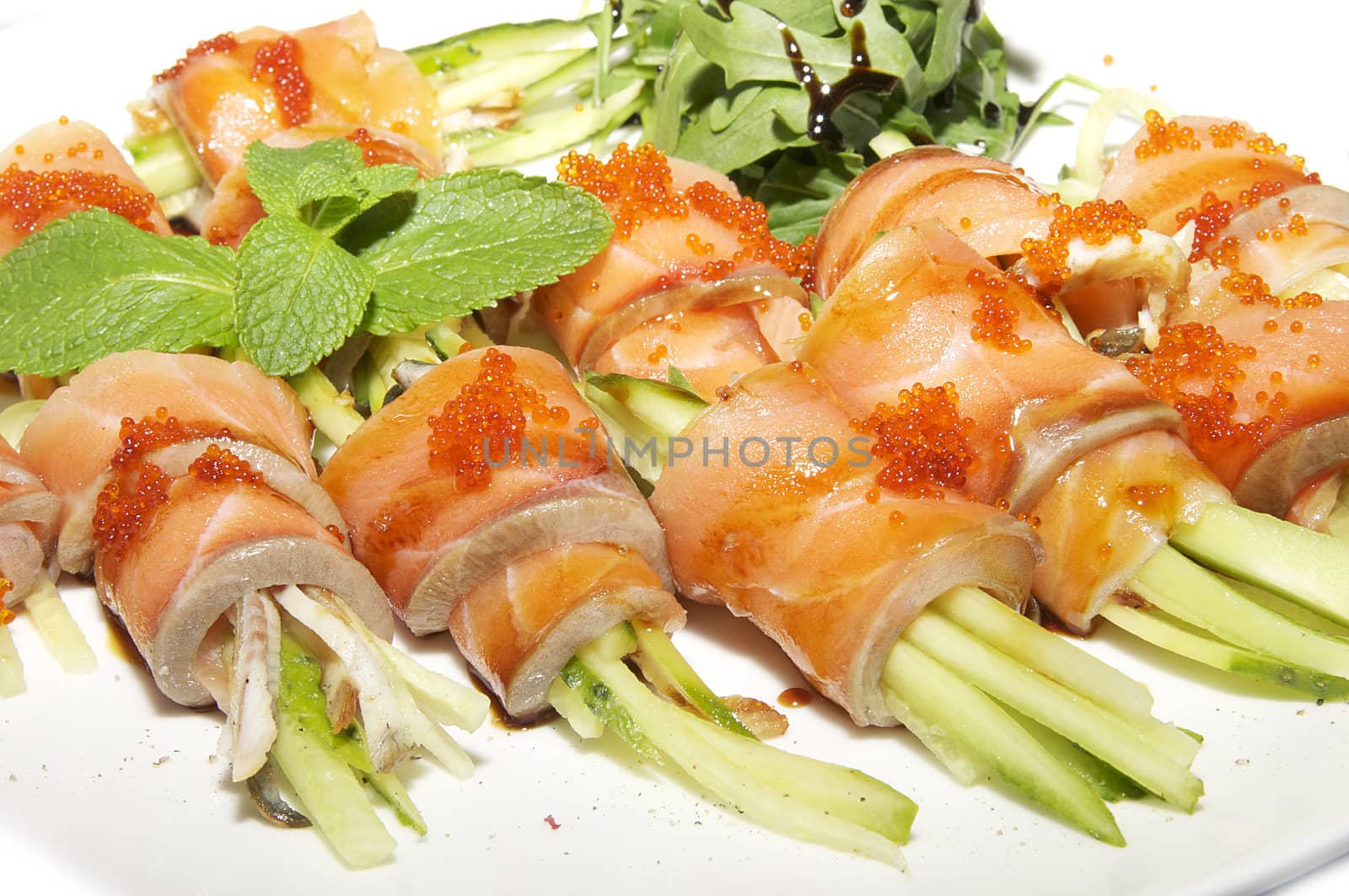 Fish rolls with herbs on a white background