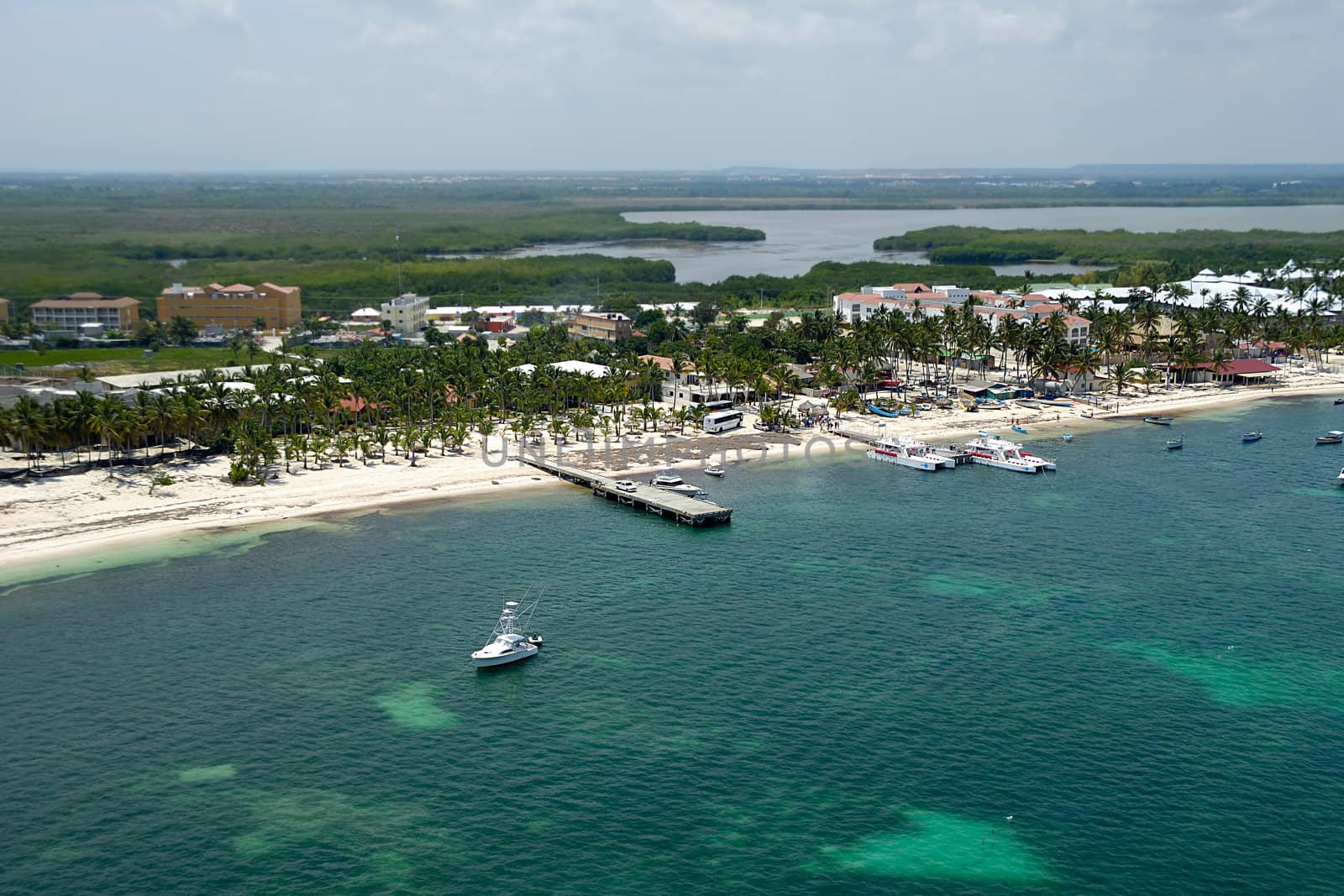 A beutiful beach in the caribbean and boats. Taken form helicopter. Dominican Republic.