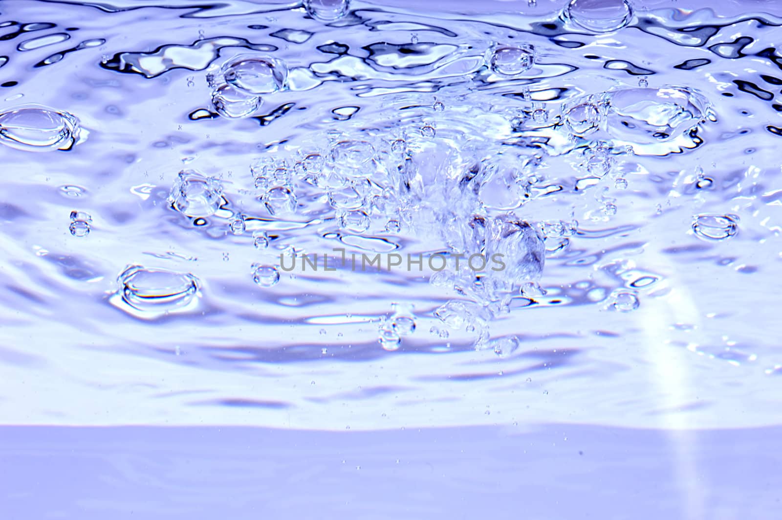 Blue water with air bubbles in the water line. 