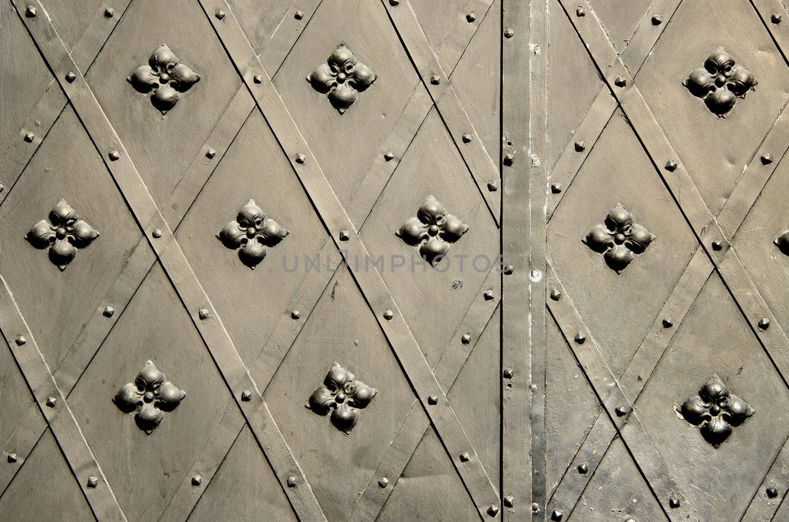 background of metal blacksmith handmade decorative doors . ancient architecture of castle gate backdrop.