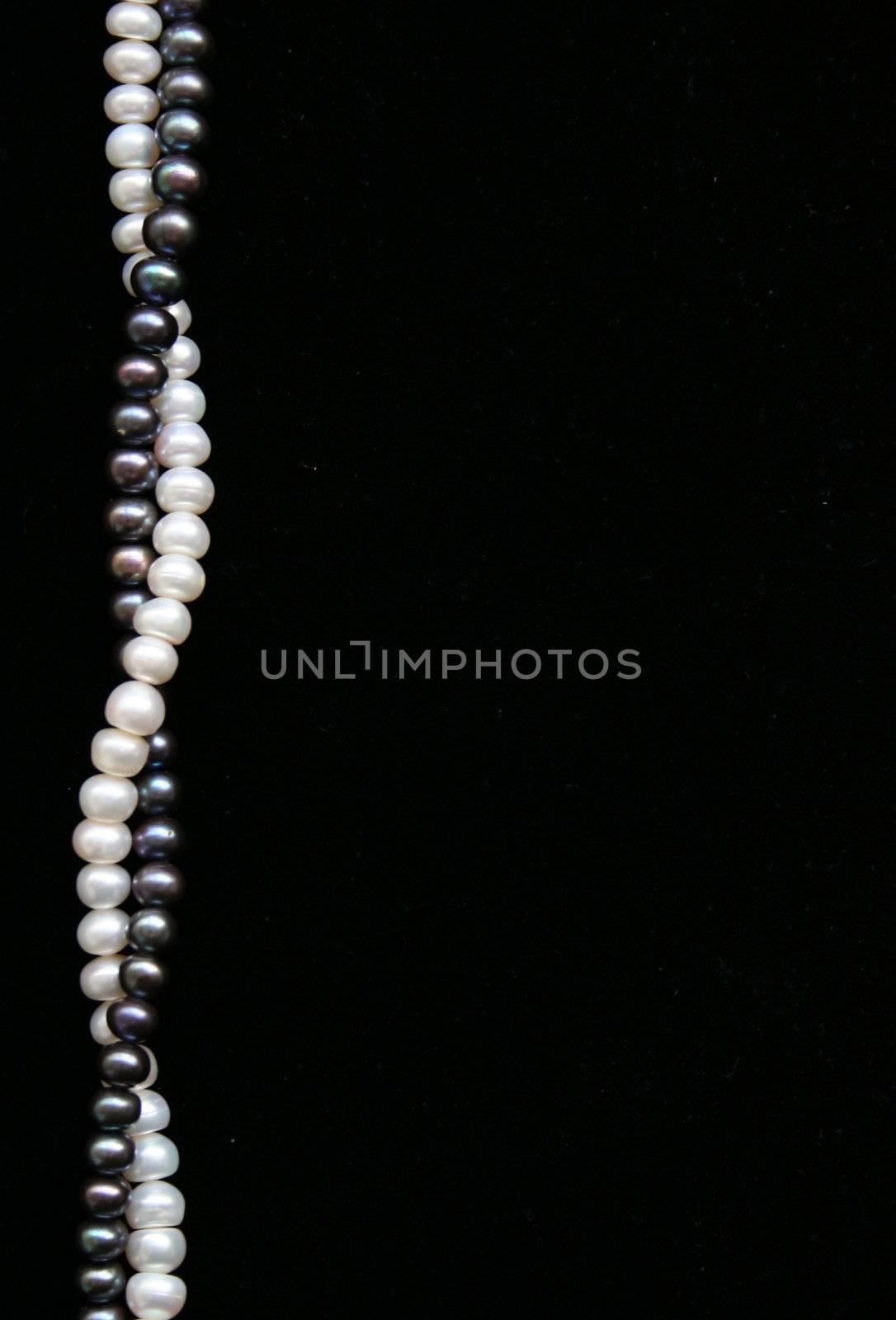 White and black pearls on the black velvet can use as background