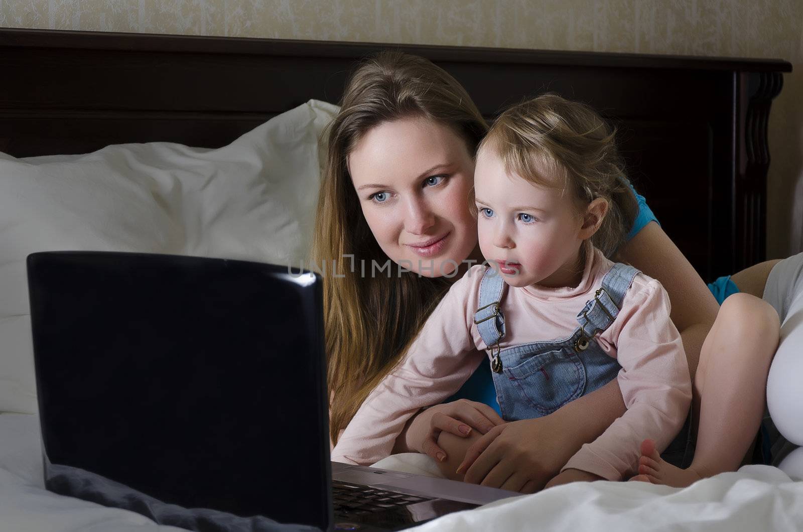 Happy family watching a cartoon on the laptop