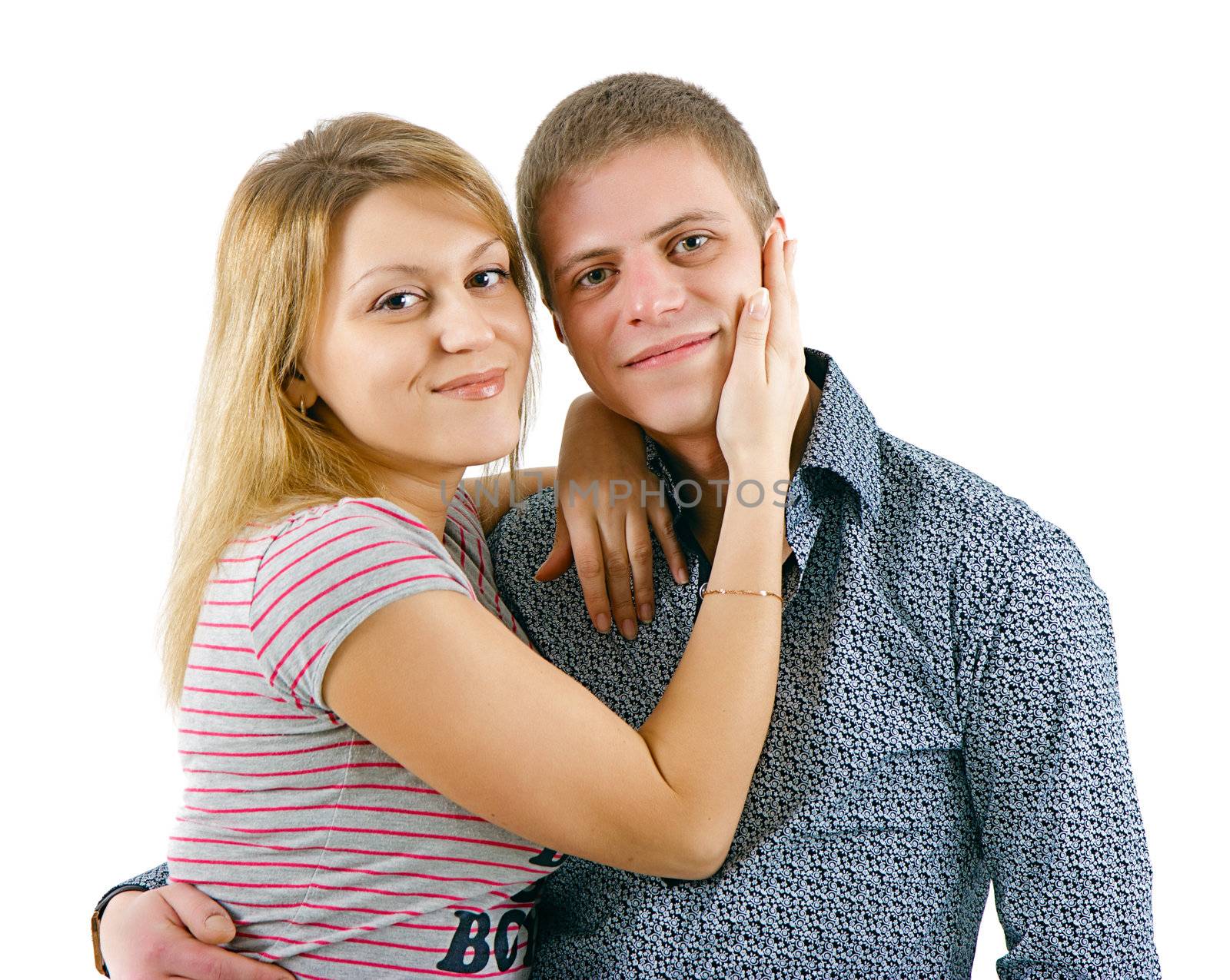 happy young couple embracing on a white background