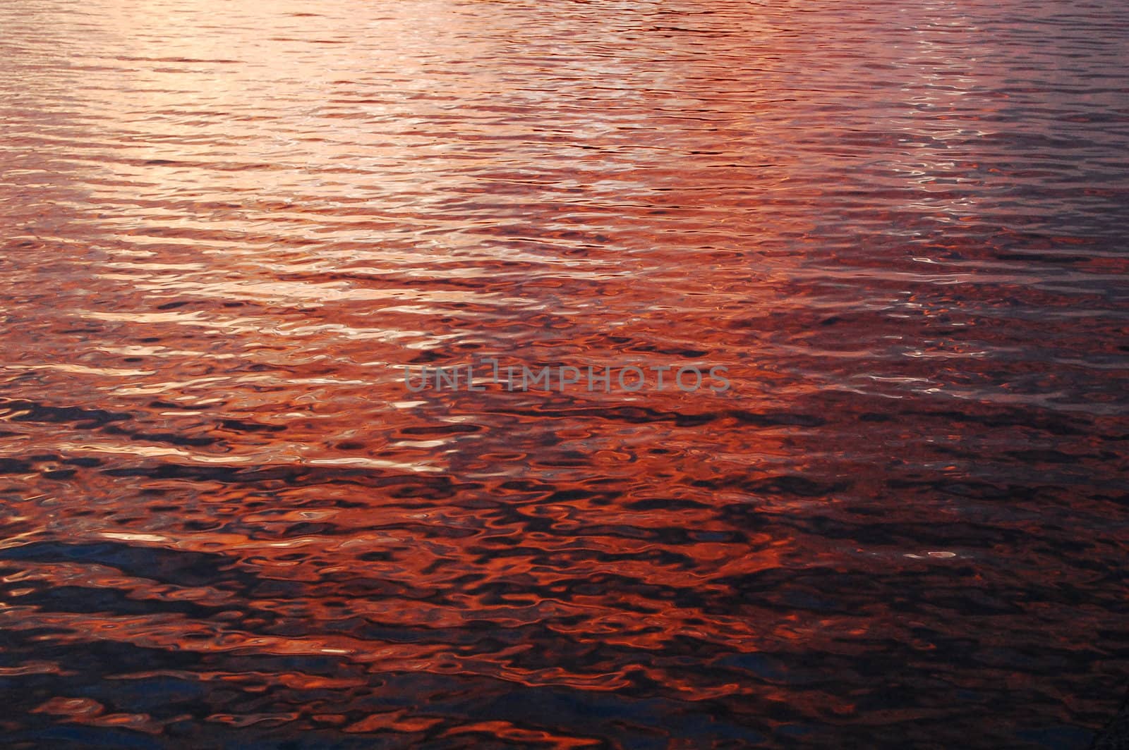 deep color sunset reflections on beach water