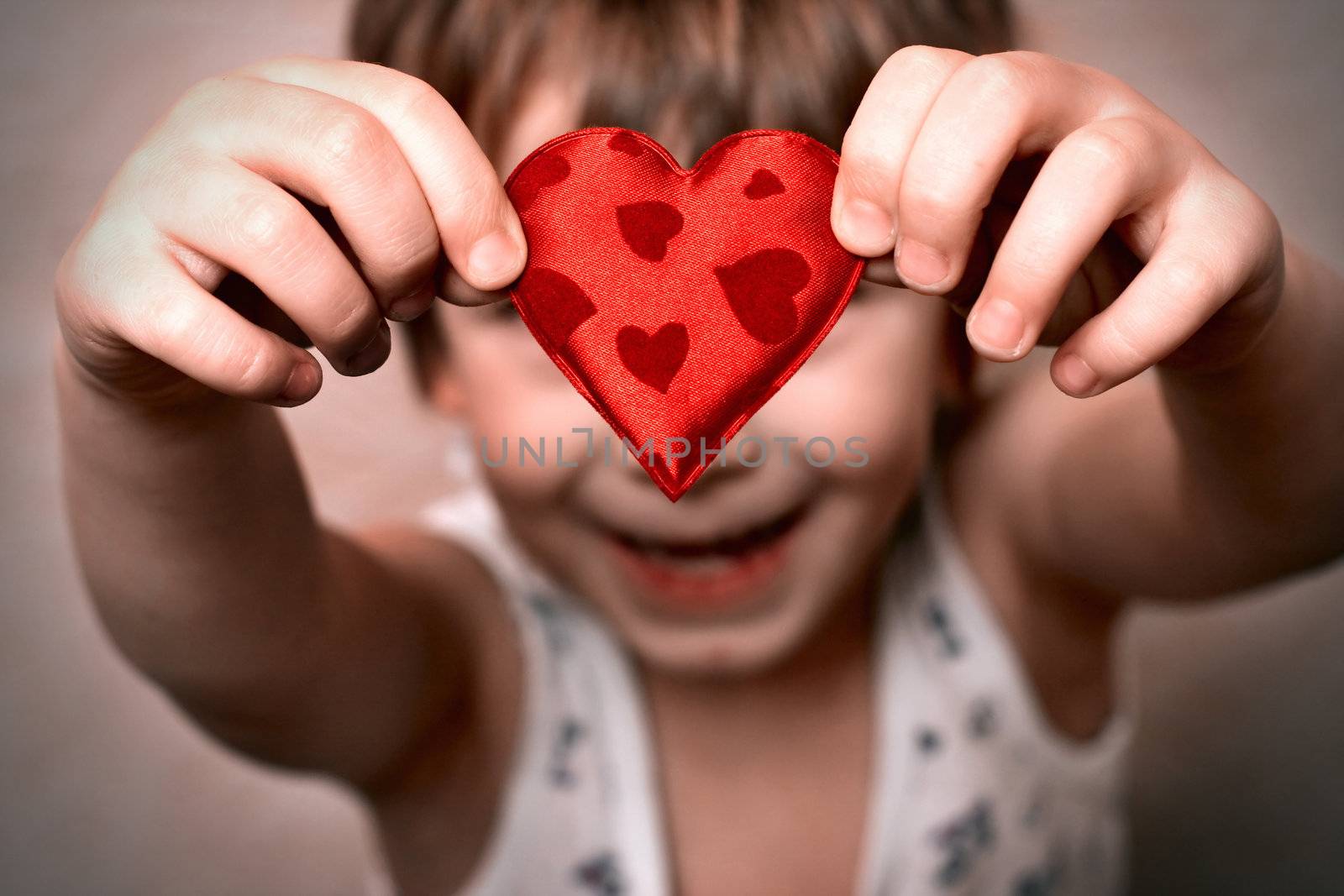 two hands holding a red heart