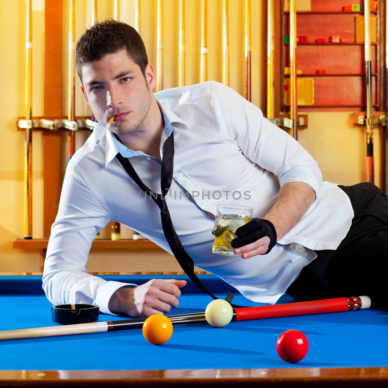 Billiard handsome player man drinking some alcohol in club