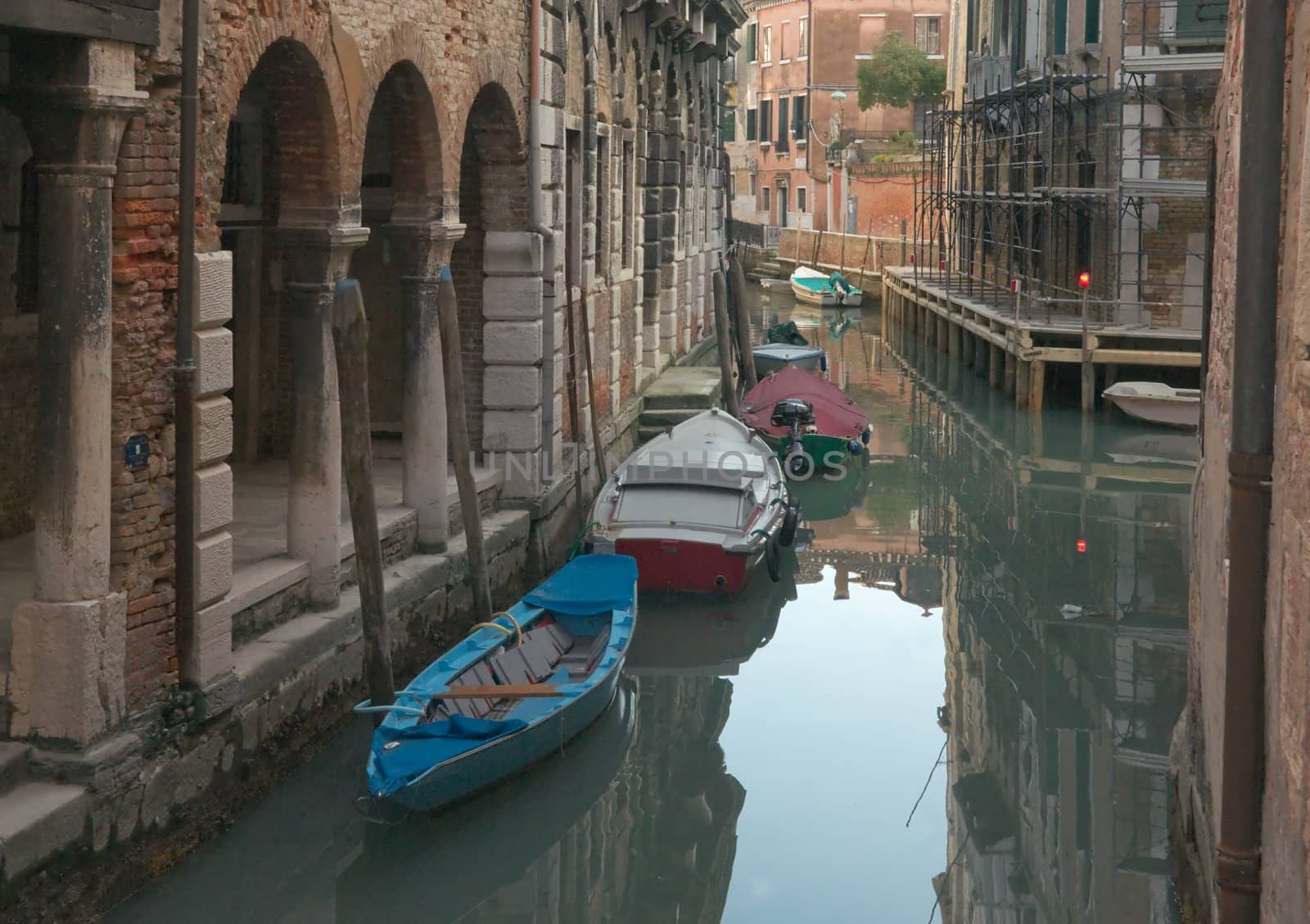 Venice Canal at dusk. Boats and reflections.