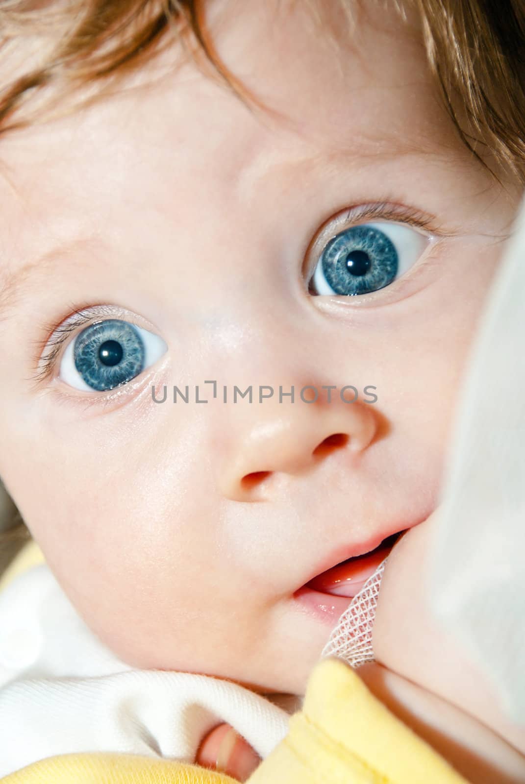 Closeup face of a beautiful baby with blue eyes.