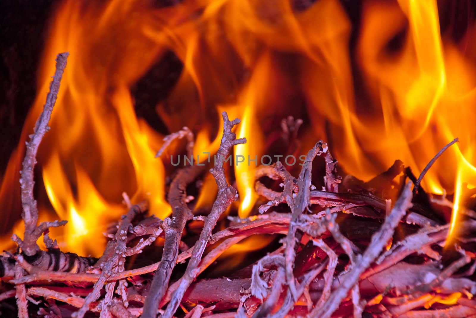 Burning wood in the fireplace and the flames.