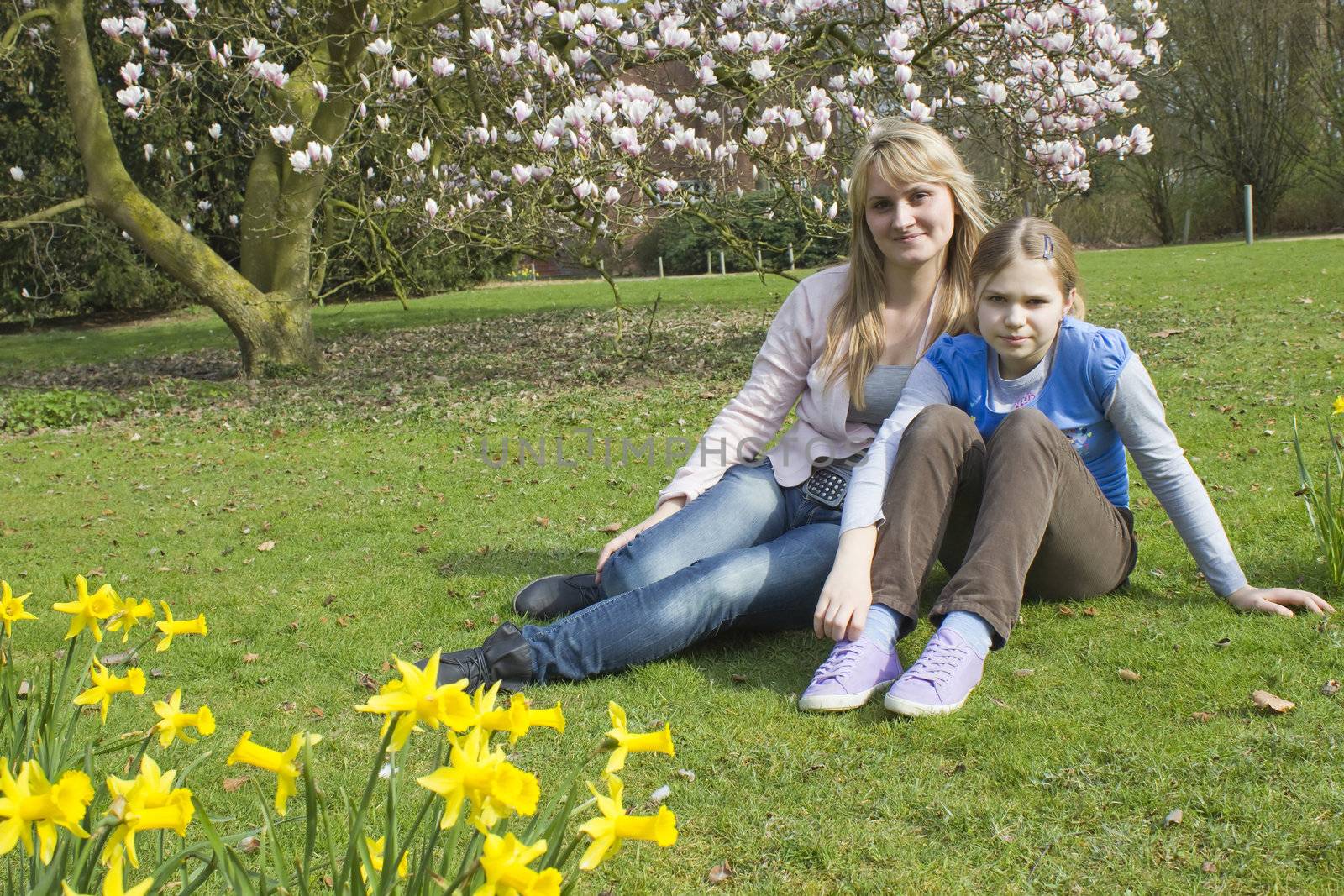 young woman and little girl in the park on a warm spring day