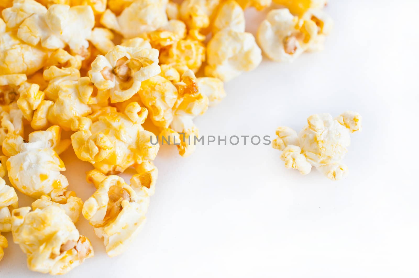 Salted popcorn grains on the white background