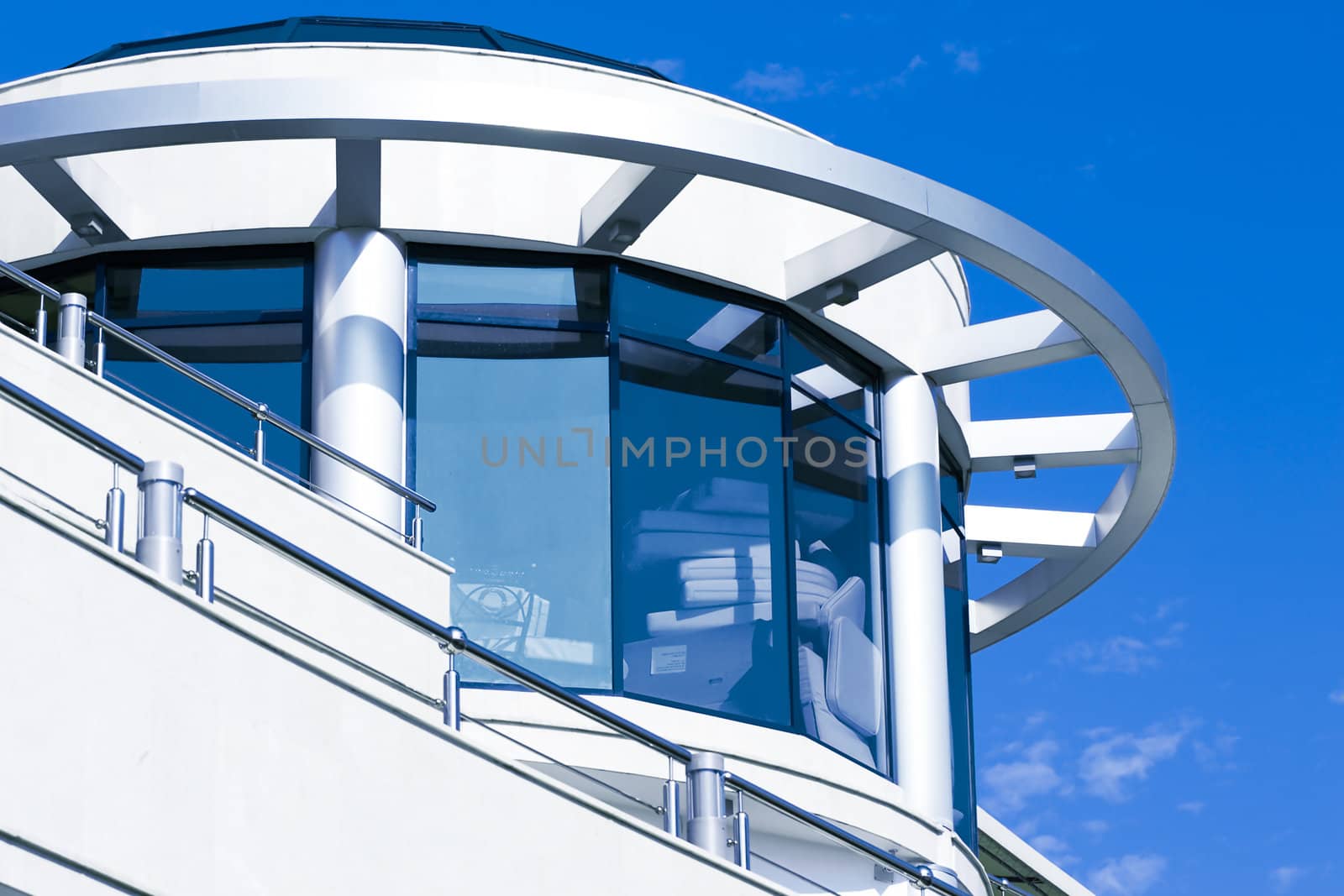 facade of modern building in blue and white tones on a background bright sky