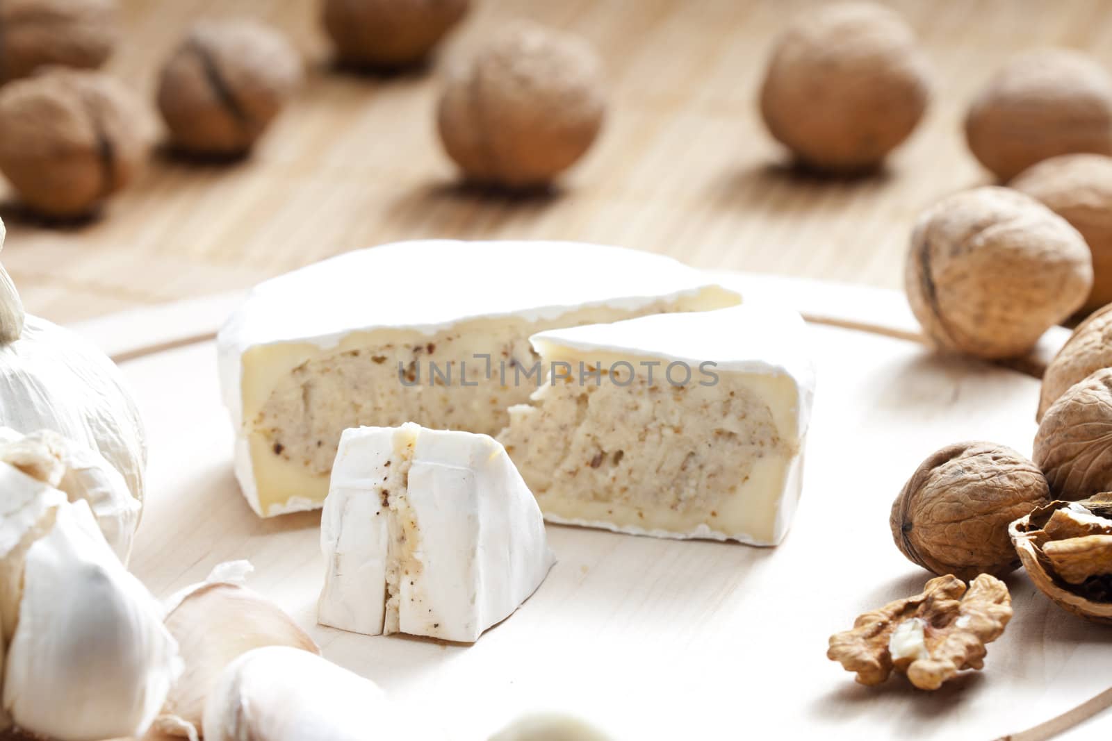 cheese brie filled with cheese mixture of chopped walnuts and garlic