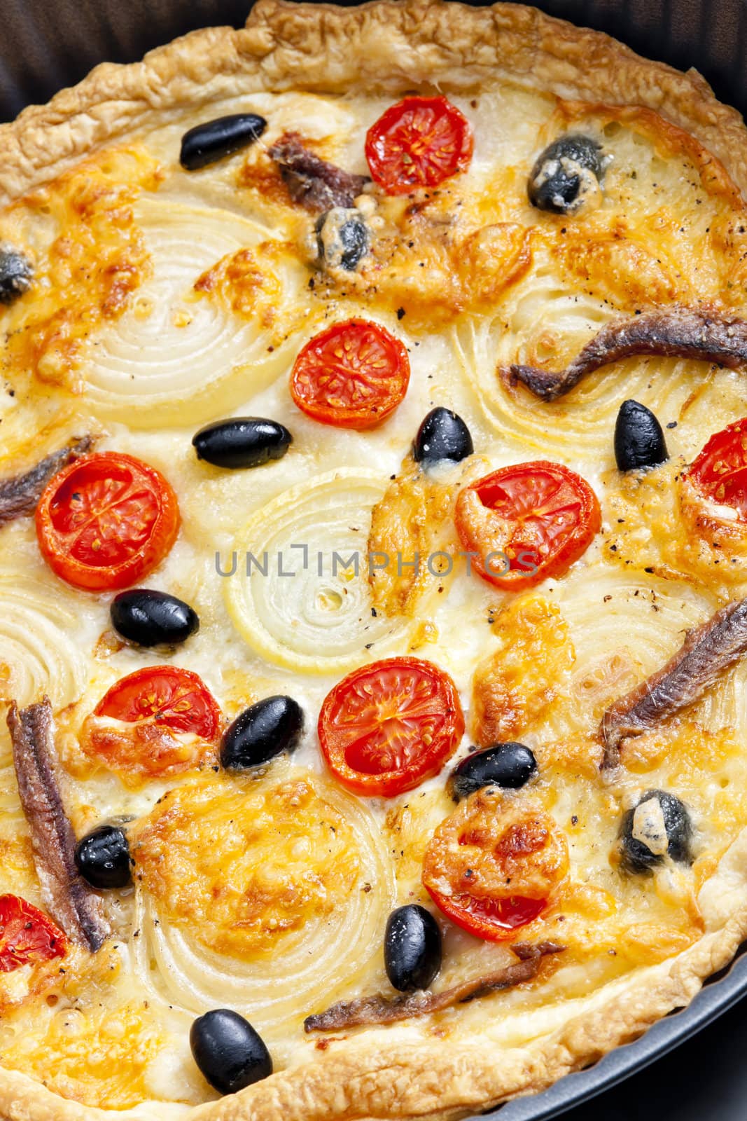 cake with anchovies, cherry tomatoes and black olives