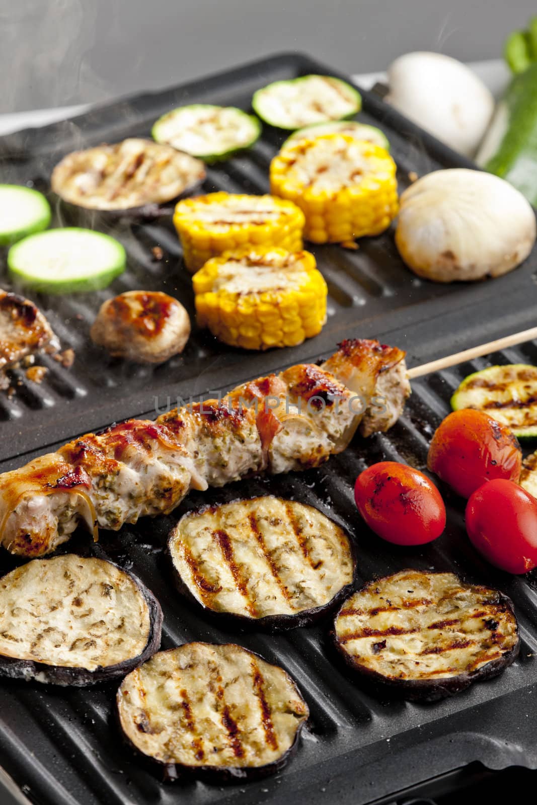 meat skewer and vegetables on electric grill by phbcz