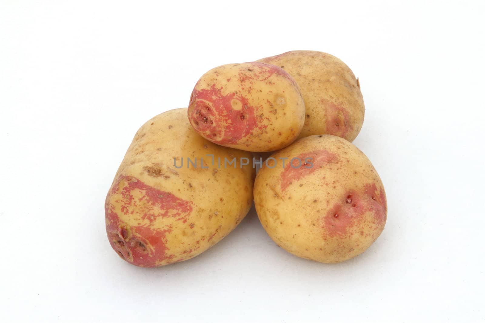 Organic potatoes on a white background.