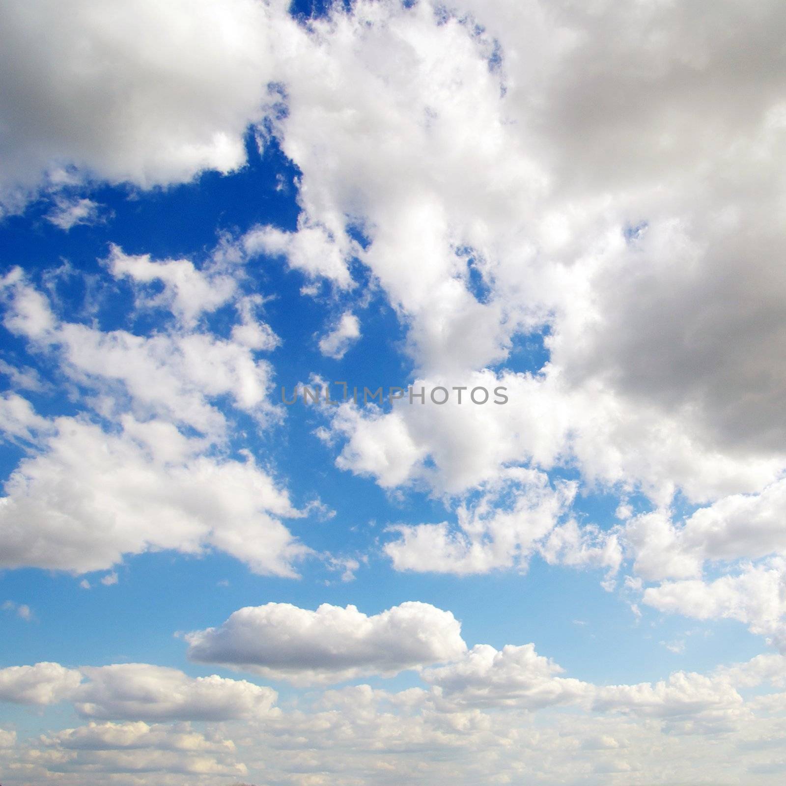 Blue sky background with tiny clouds