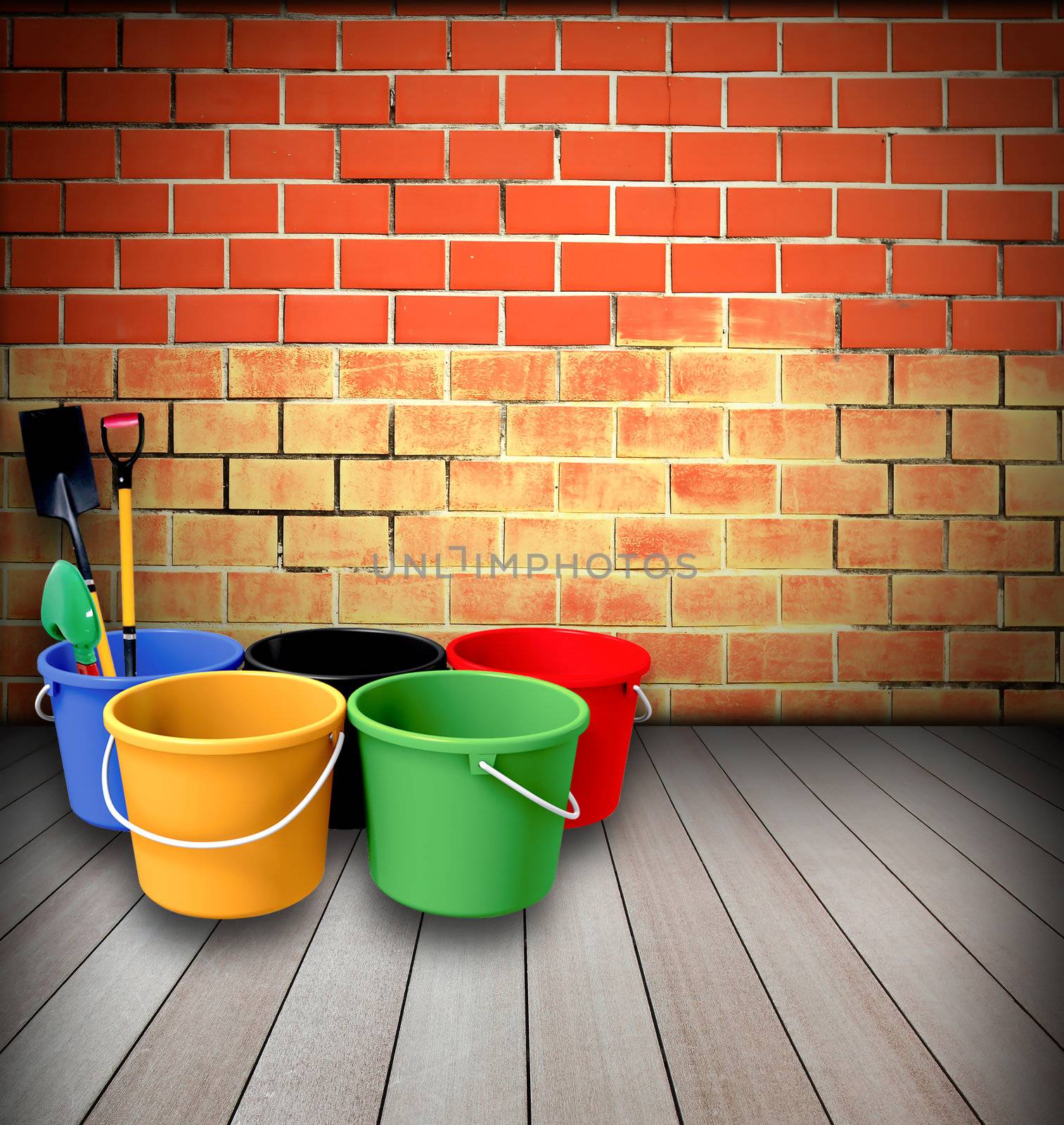 Bucket and shovel with a brick wall.