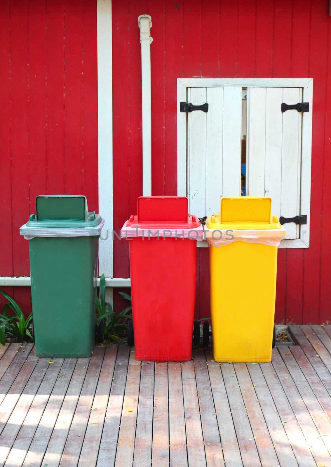 Colorful recycle bins in front of the house