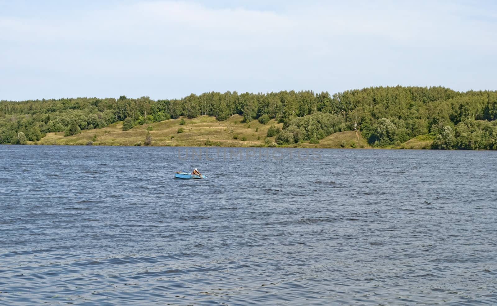 Bank of the Volga river with a lone fisherman in a boat