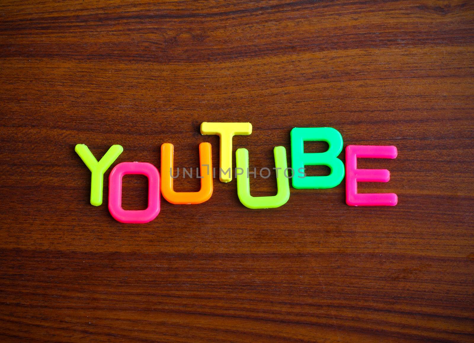 Youtube in colorful toy letters on wood background  by nuchylee