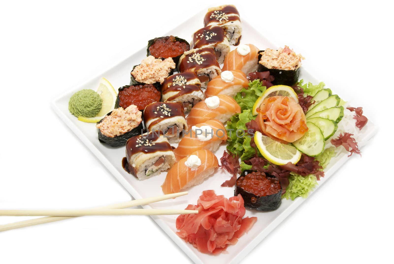 a plate of sushi and salad on a white background