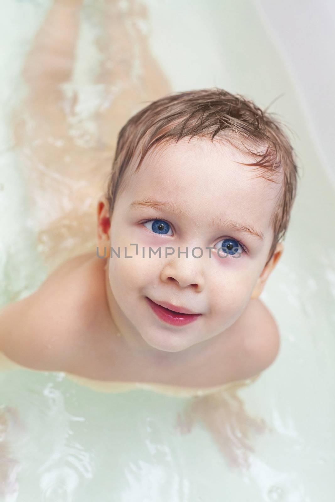 Adorable baby taking bath and swim on chest