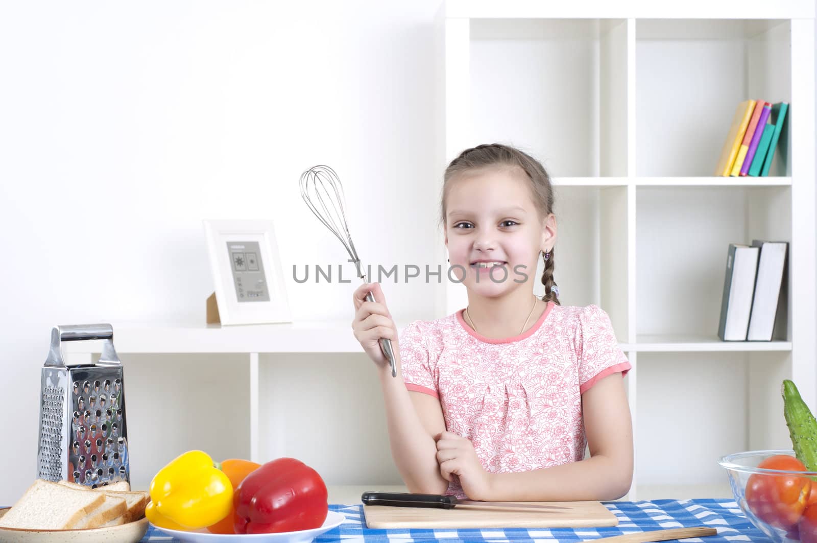 Beautiful girl holding a mixer, work in the kitchen