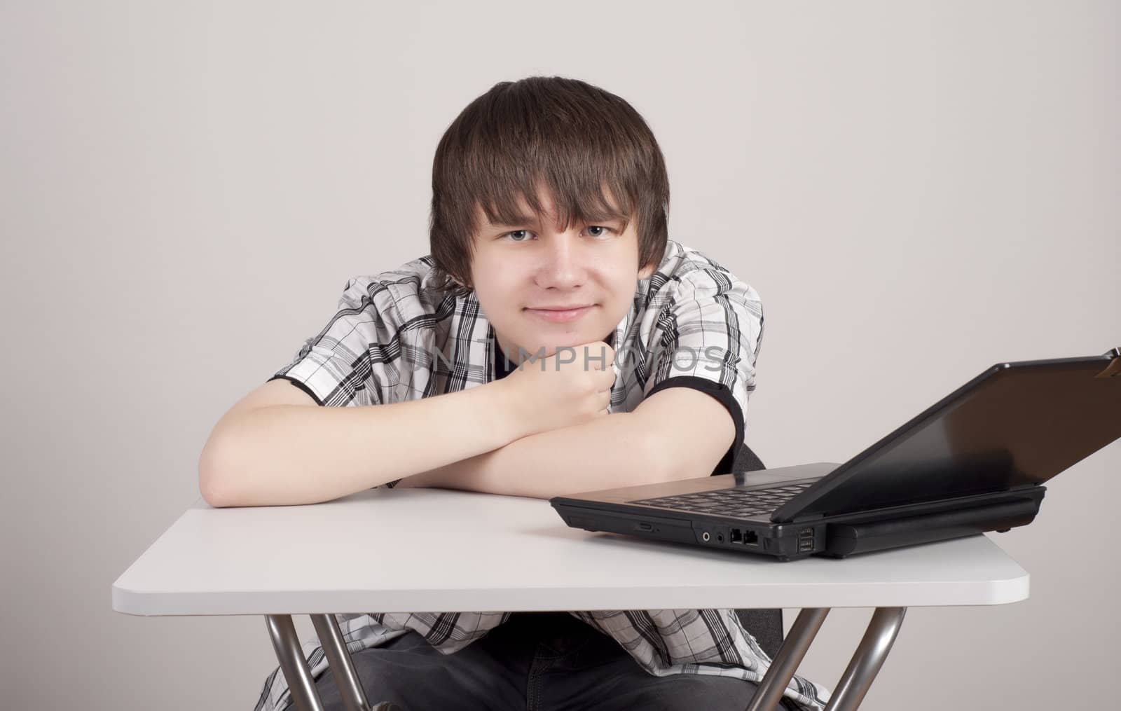 student sits for a portable computer by adam121