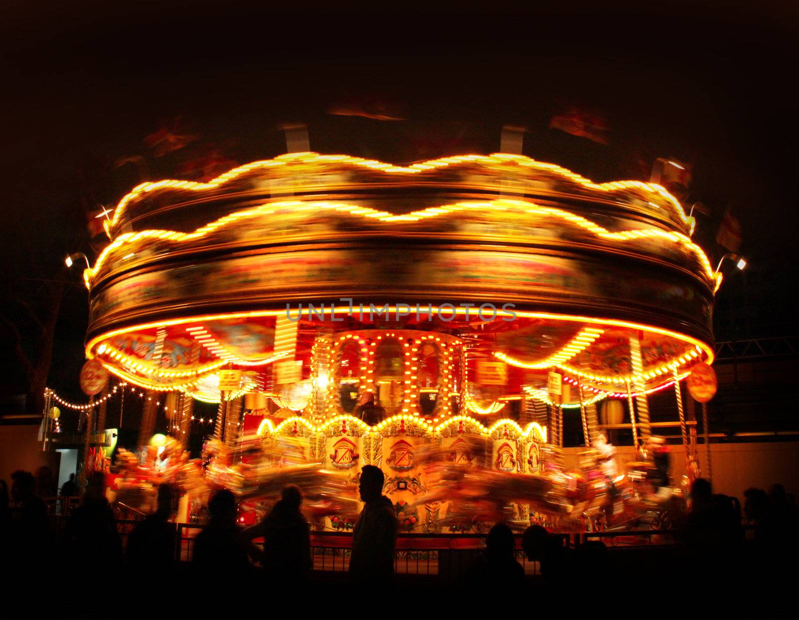 Spinning carousel lights motion in amusement park night