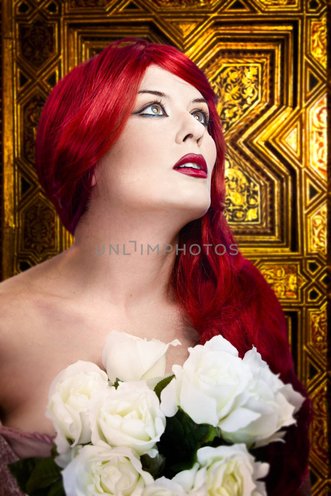 Gothic woman, faith concept. Red hair beautiful girl over medieval gold background